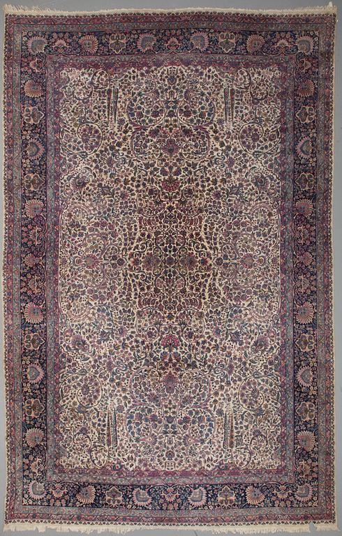 A CARPET, a semi-antique Kerman, ca 601 x 387 cm.