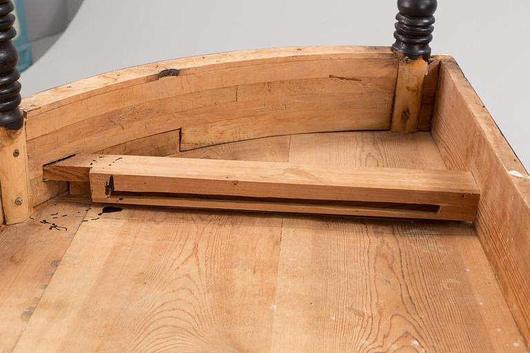 A round dining table, circa 1900.