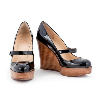 598. CHRISTIAN LOUBOUTIN, a pair of black patent wegde shoes, "Mary Jane Wallis". Size 37.
