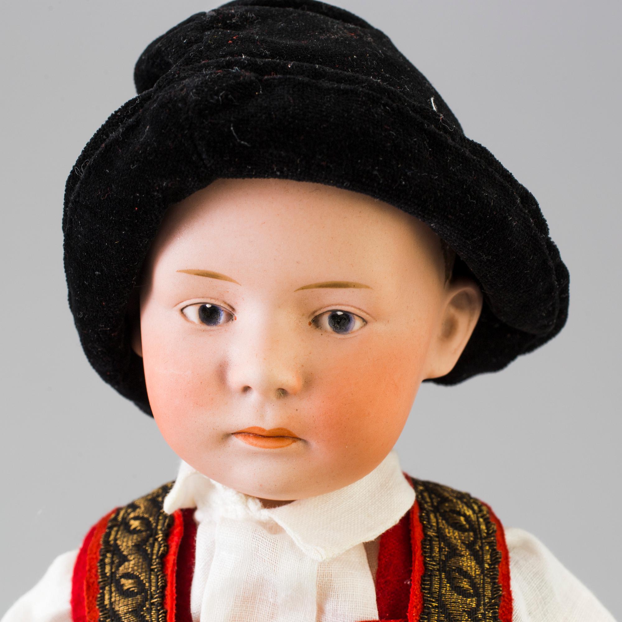 A bisque headed boy doll by Heubach, Germany, 1910s.