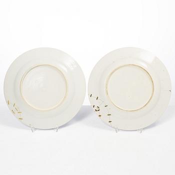 A pair of armorial dinner plates, soft paste, Qing dynasty, 18th century.