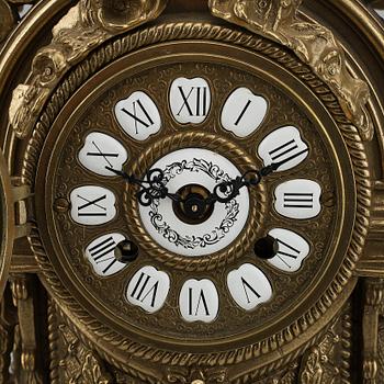 A 20th Century set of a brass mantle clock and a pair of candelabras.