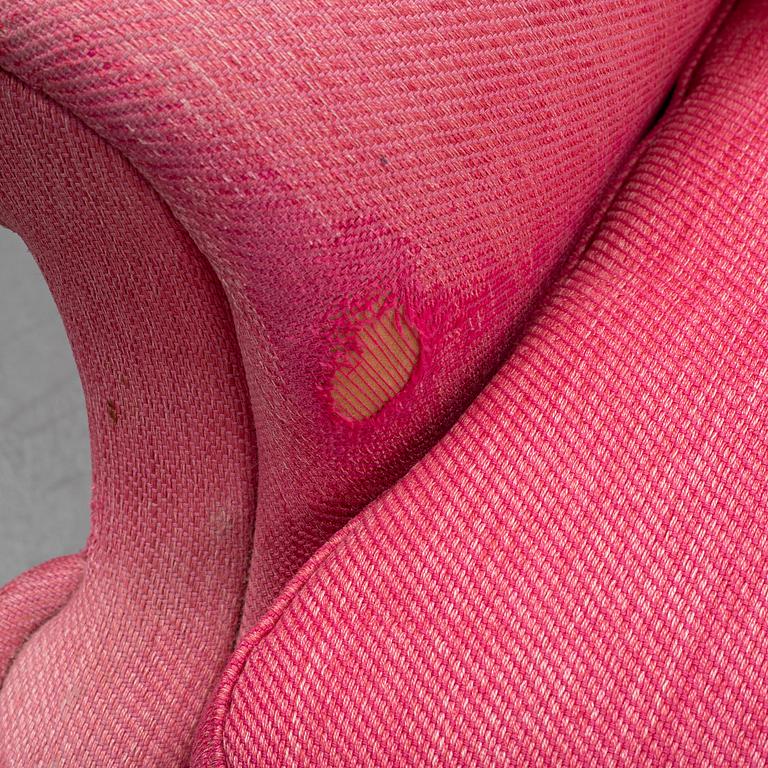 An 'Oxford' model no 3543 easy chair with stool by Ragnar Helsén for Firma Svenskt Tenn.