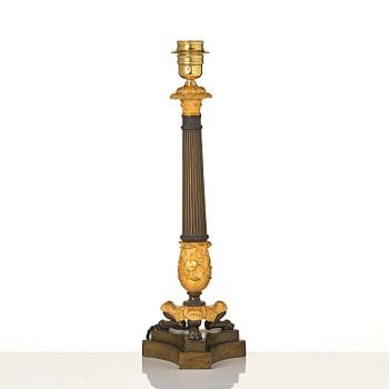A French Empire ormolu and patinated bronze table lamp, early 19th century.