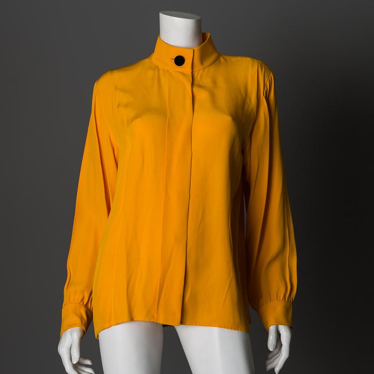 A blouse by Yves Saint Laurent, size 42 (FR).