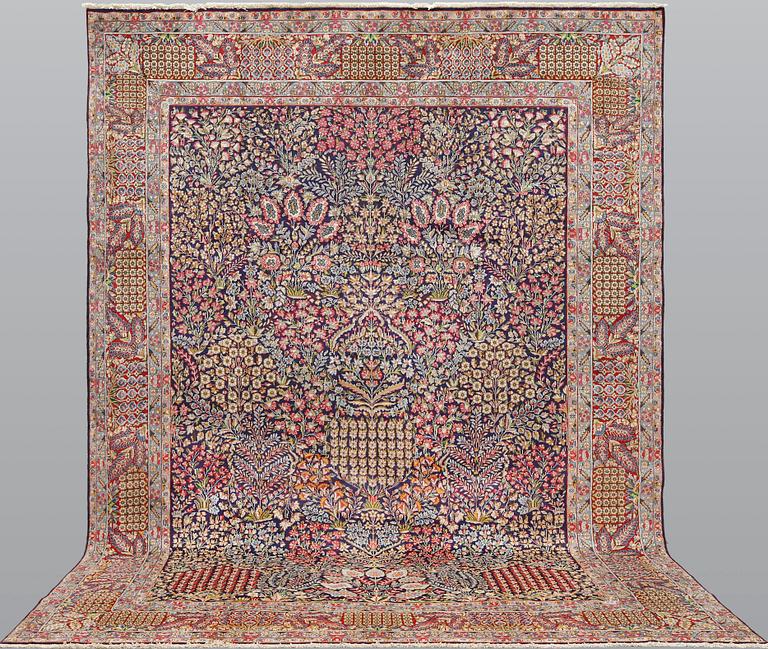 A 'Millefleur' Kerman Laver carpet, c. 402 x 284 cm.