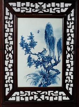 A four panel screen with porcelain placques, Qing dynasty, 19th Century.