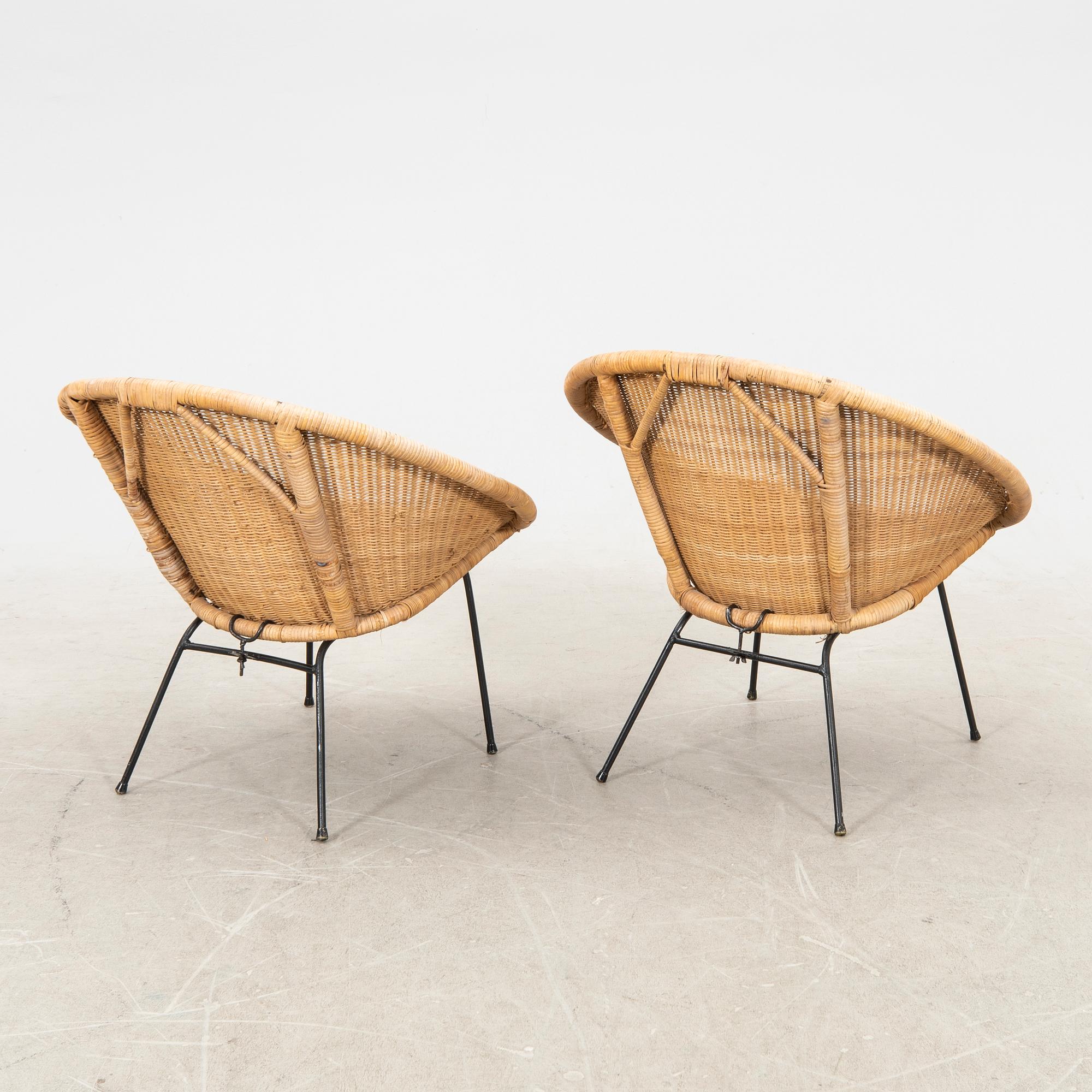 A pair of rattan 1950s easy chairs.