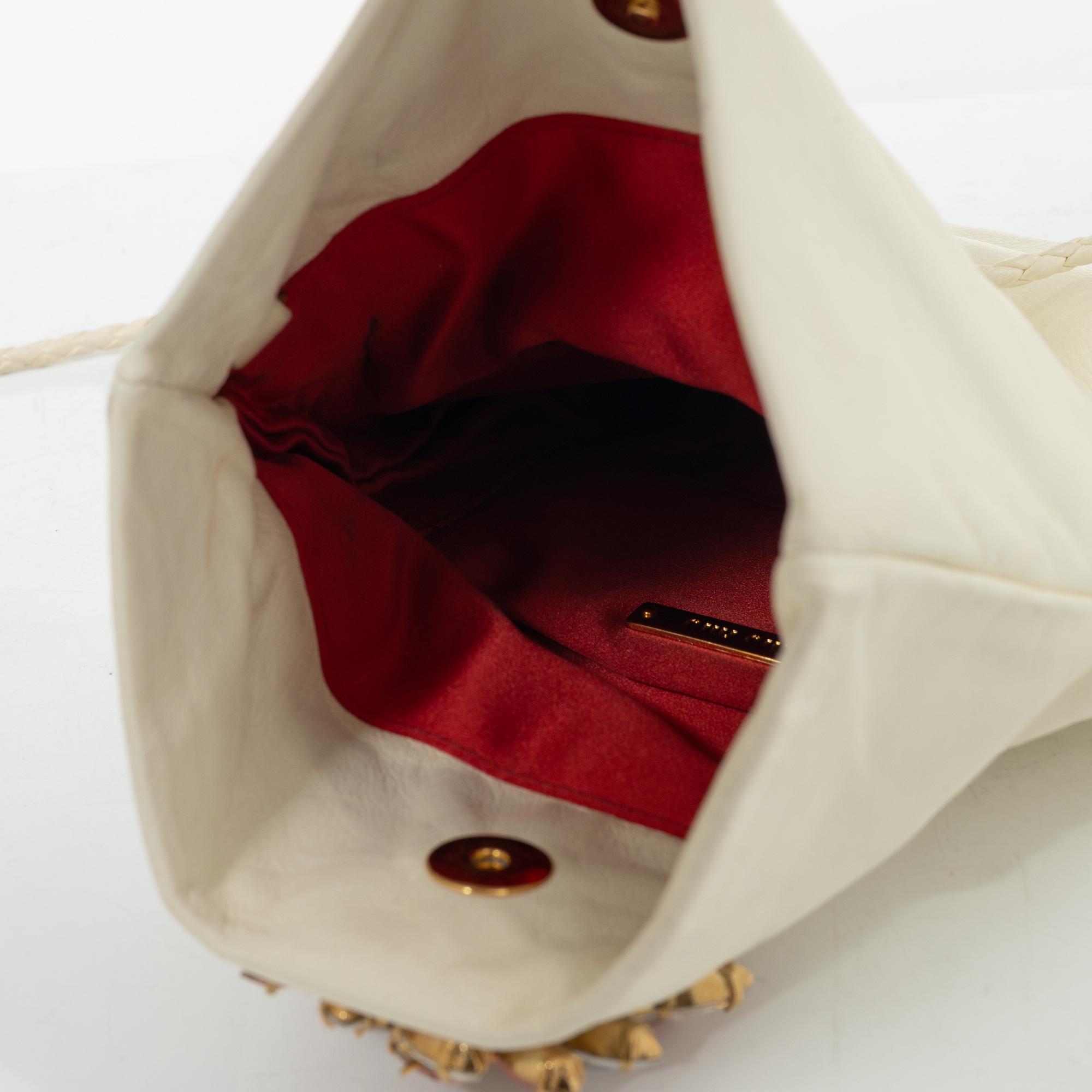 Miu Miu, a handbag/clutch.