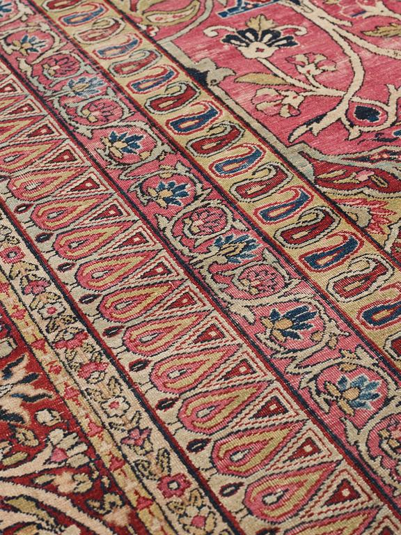 A CARPET, an antique Kerman Laver, ca 363 x 301 cm.