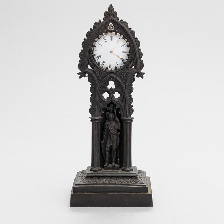 A neo-gothic cast iron pocket watch stand with a pocket watch. 19th century.