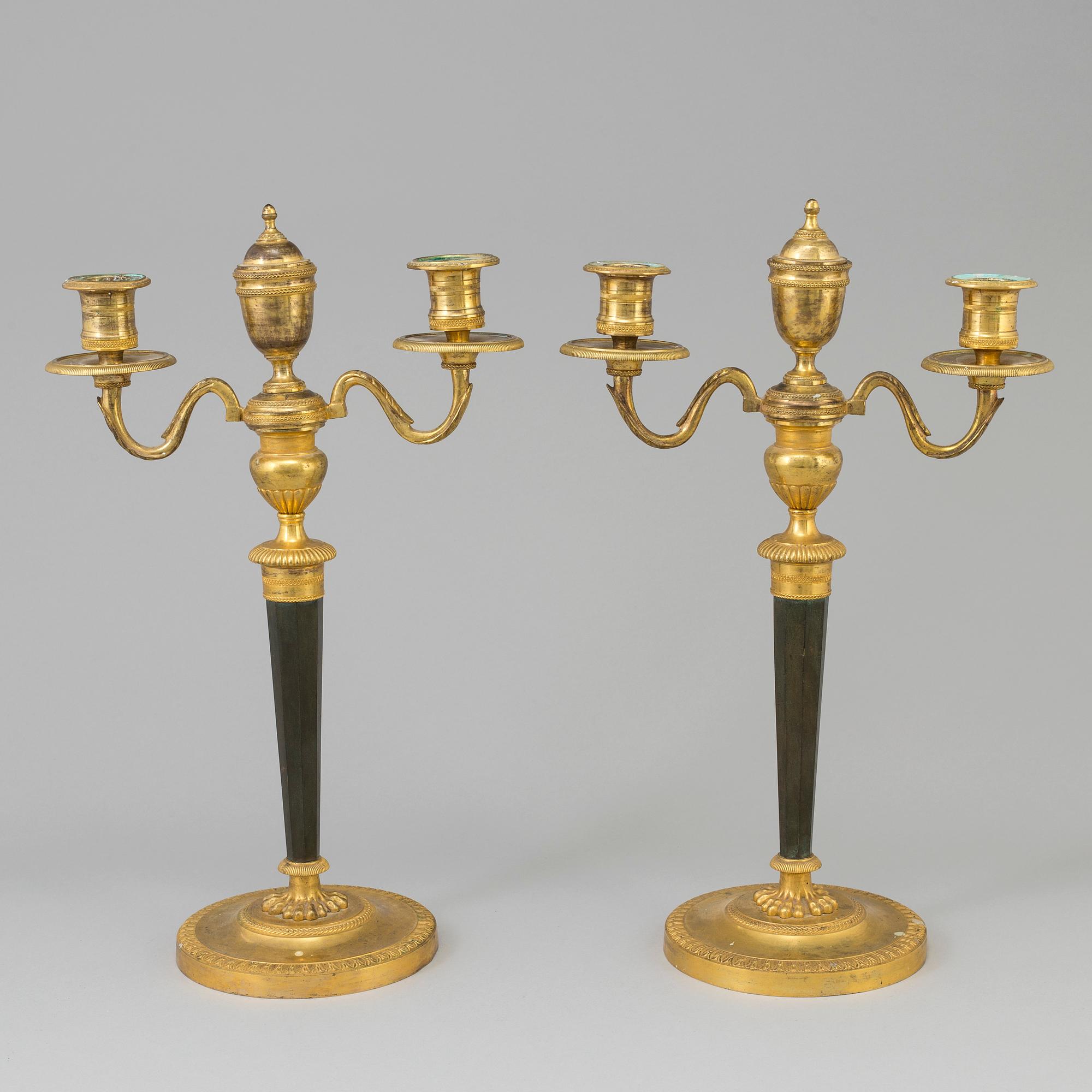 A pair of French Directoire late 18th century ormolu candelabra for three candles.