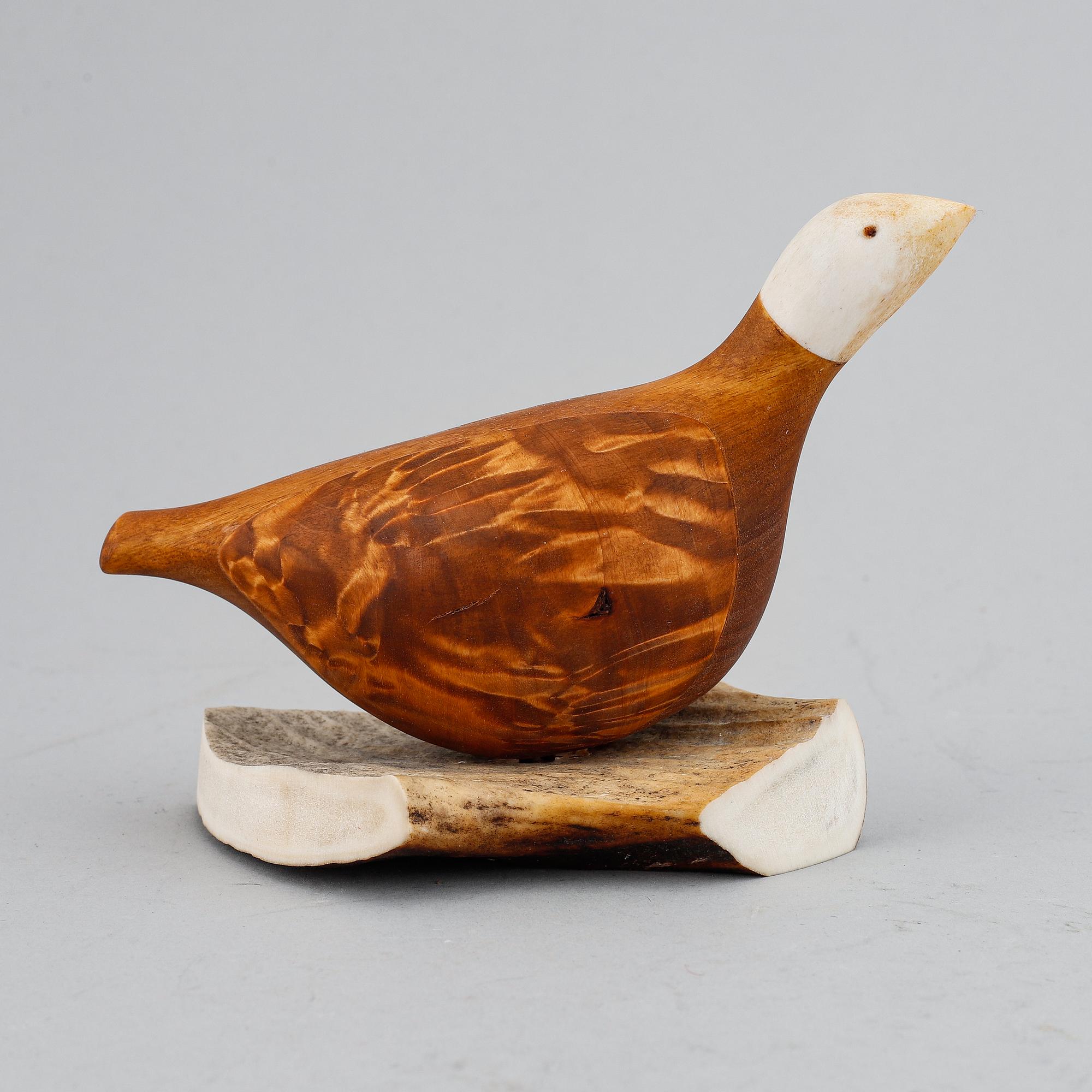Lars Levi Sunna, a Sami reindeer horn and birch figurine of a grouse, signed LL Sunna.