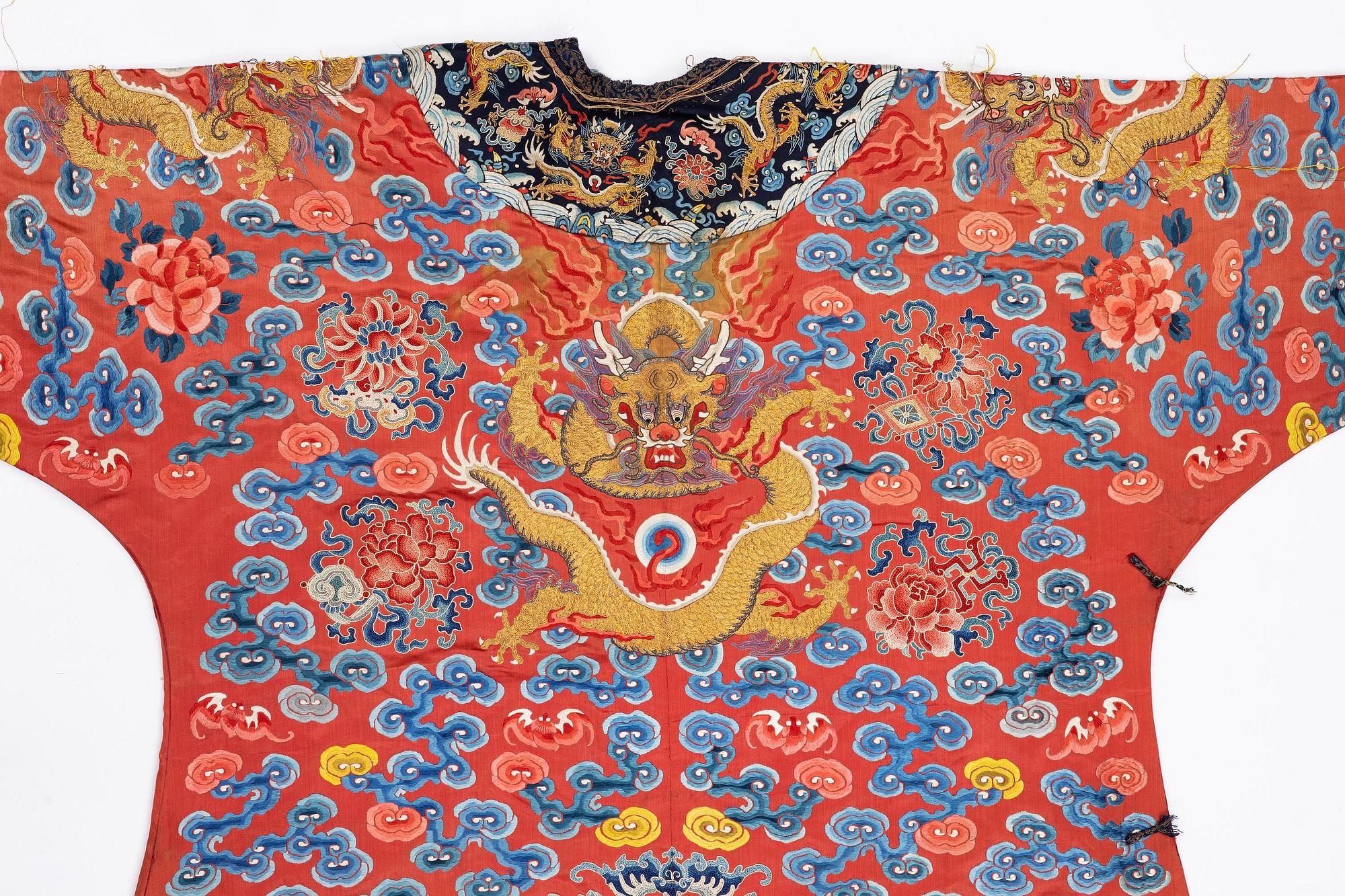 An embroidered red ground five clawed dragon 'female' formal robe, Qing dynasty, 19th century.