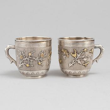 A pair of Chinese silver coffee cups with liners, early 20th Century.