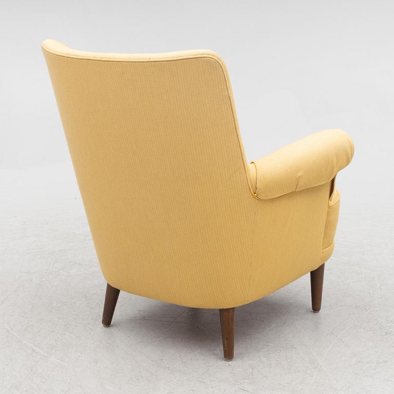 Carl Malmsten, a 'Hemmakväll' armchair and a 'Farmor' ottoman.