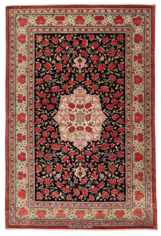 A signed silk Qum rug. c. 154 x 103 cm.