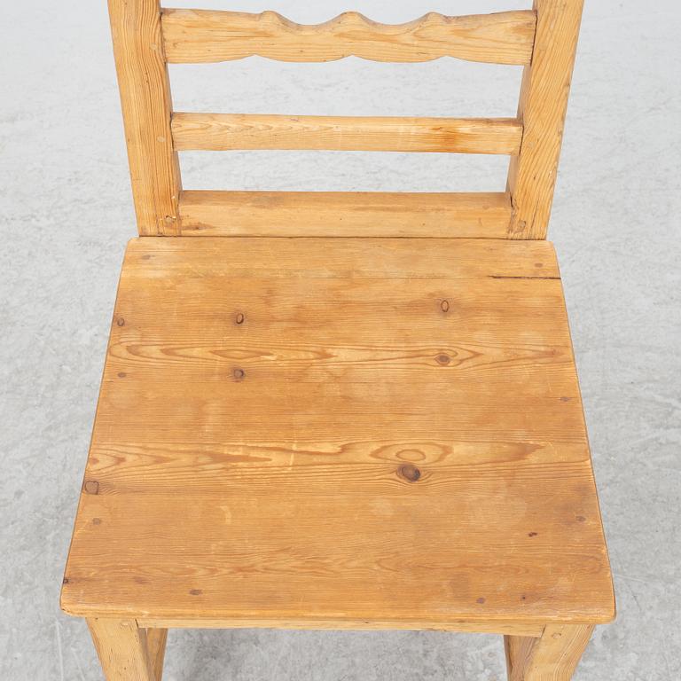 A gateleg table eith 6 + 6 chairs.