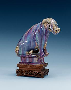 1472. A flambé-glazed porcelain figure of a pig, Qing dynasty, 18th/19th Century.