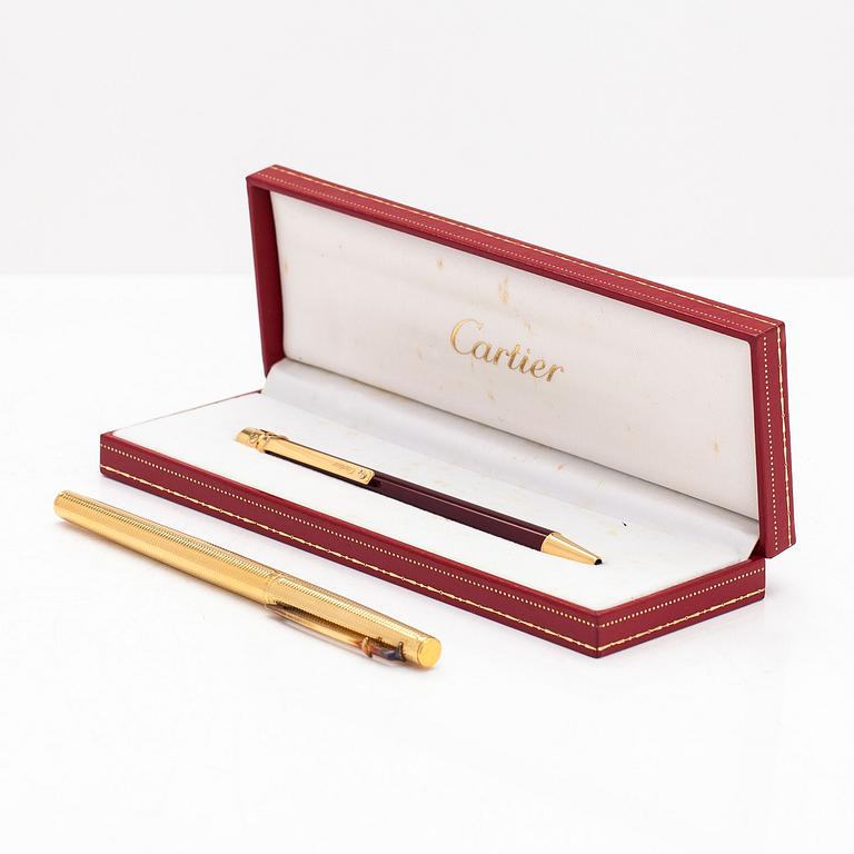 Two pens by Cartier and Caran d'Ache.