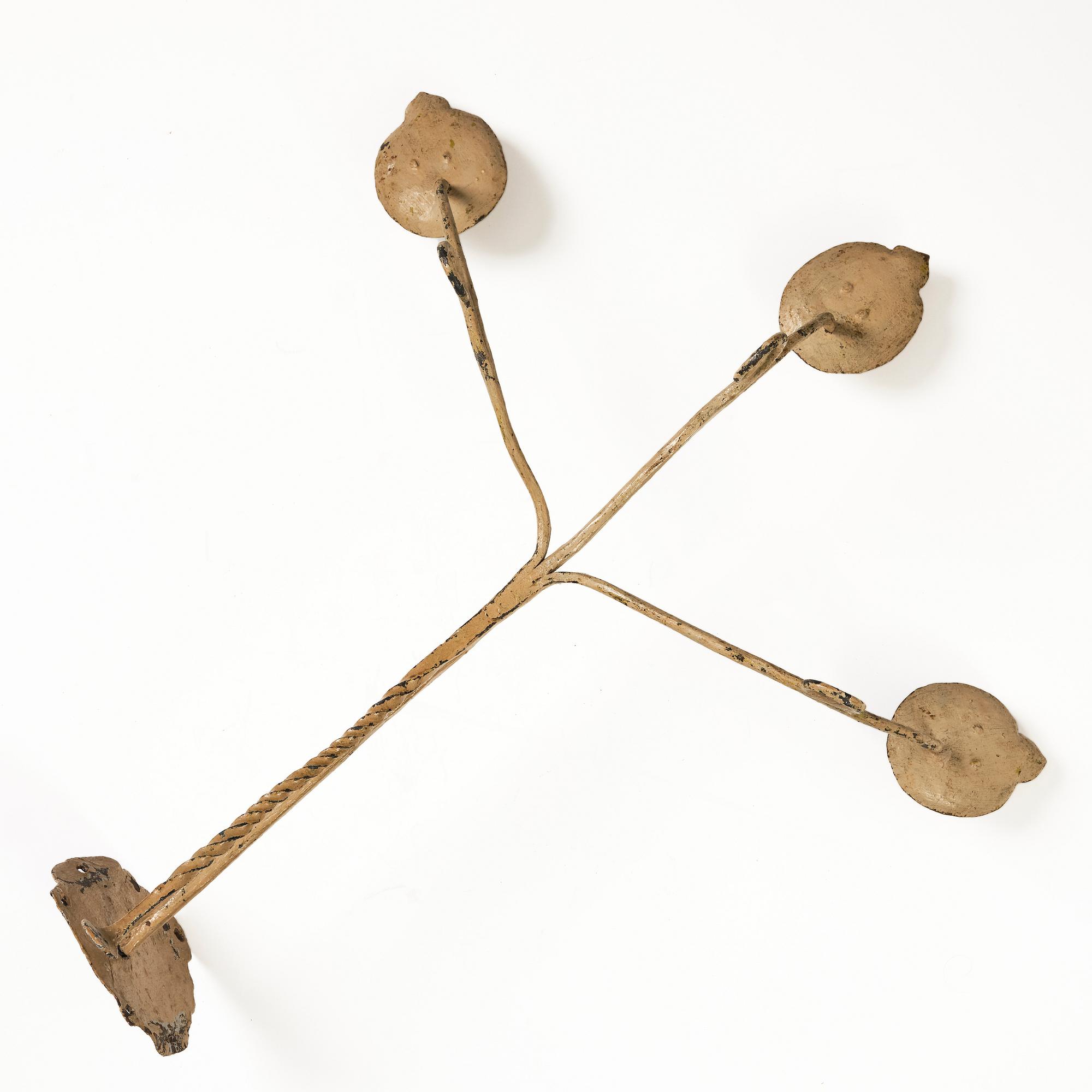 A Swedish wrought iron three-branch wall light, 17th / 18th century.