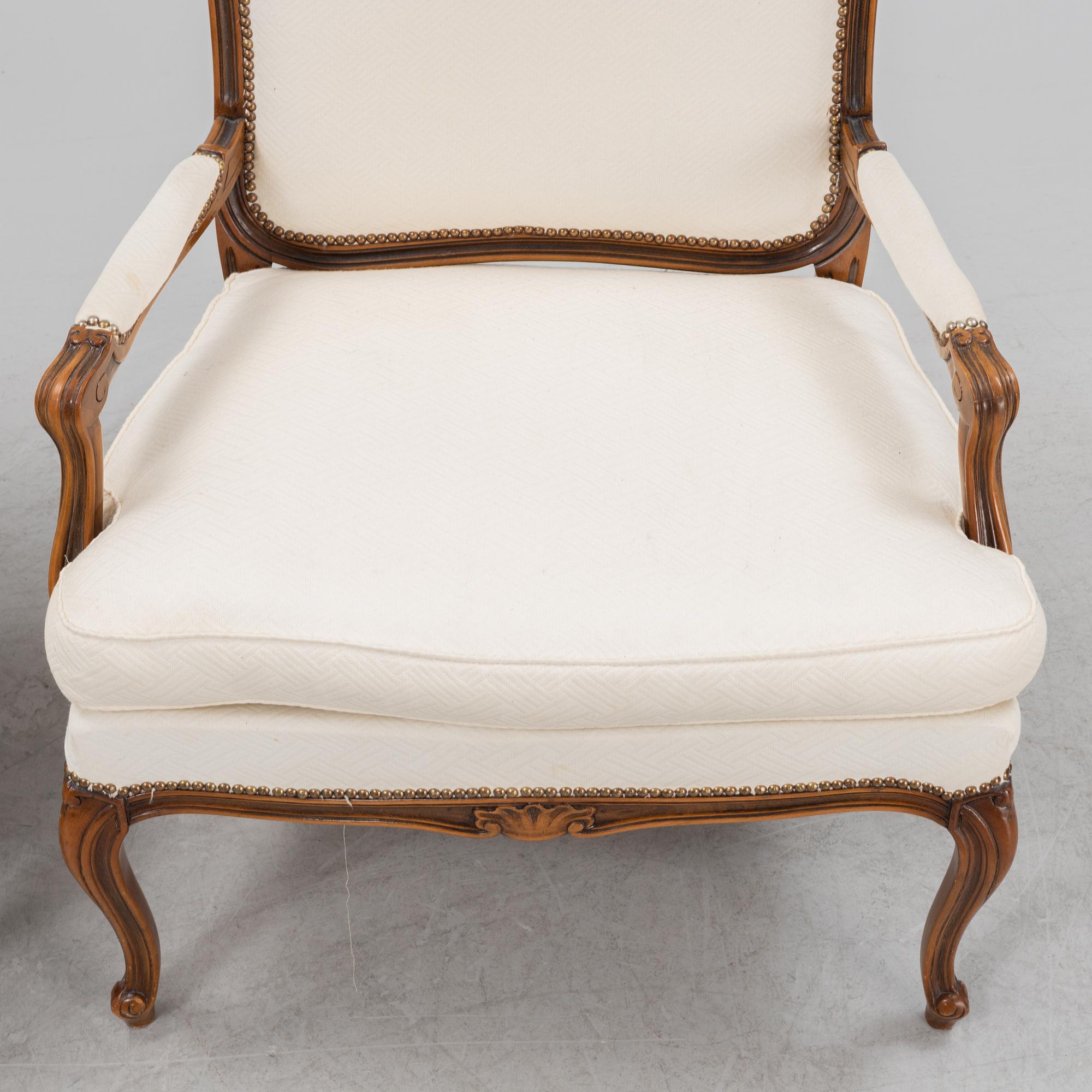 A pair of Rococo style armchairs, later part of the 20th century.