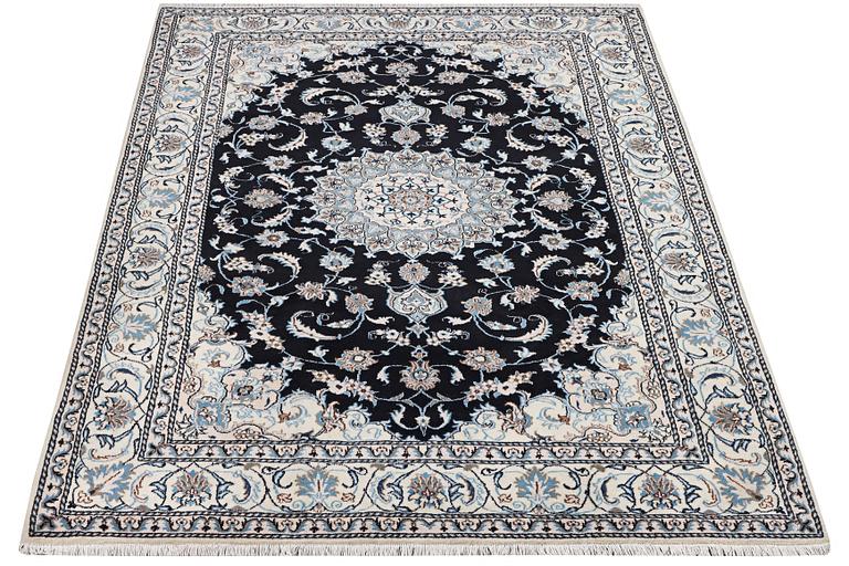 A Nain carpet, part silk, c. 286 x 206 cm.