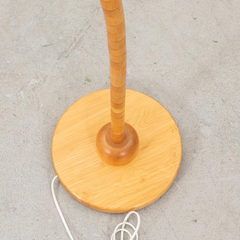 A Markslöjd 21st century wooden floor lamp.