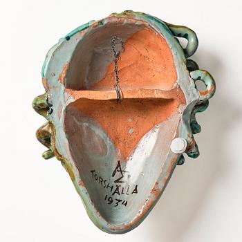Allan Ebeling, a glazed earthenware wall sculpture of a masque, Torshälla 1934.