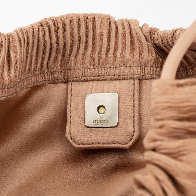 Gucci, a textile handbag.