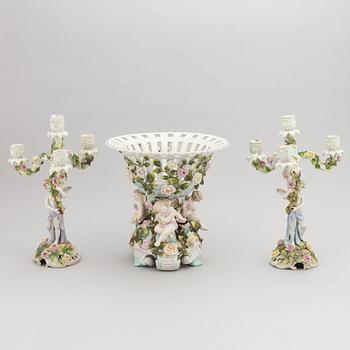 A pair of porcelain rococo style candelabra and a centerpiece bowl, Plaue, Germany, first half of the 20th century.