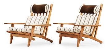 38. A pair of Hans J Wegner oak and fabric easy chairs, Getama, Gedsted, Denmark 1950's-60's.