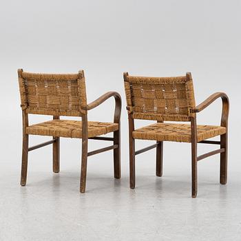 A pair of stained beech armchairs, first half of the 20th Century.