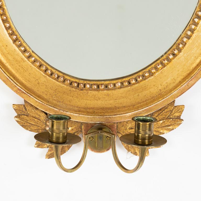 A pair of Gustavian style two-light giltwood girandole mirrors, 20th century.