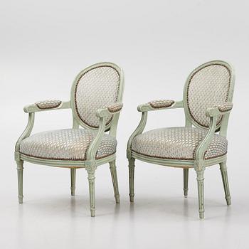 A pair of French Louis XVI open armchairs, late 18th century.