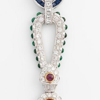 Brooch, white gold with cabochon-cut emeralds, rubies, sapphires, and brilliant- and square-cut diamonds.