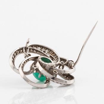 A white gold, cabochon cut emerald and diamond brooch.