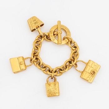 Céline, a gold tone charm bracelet.