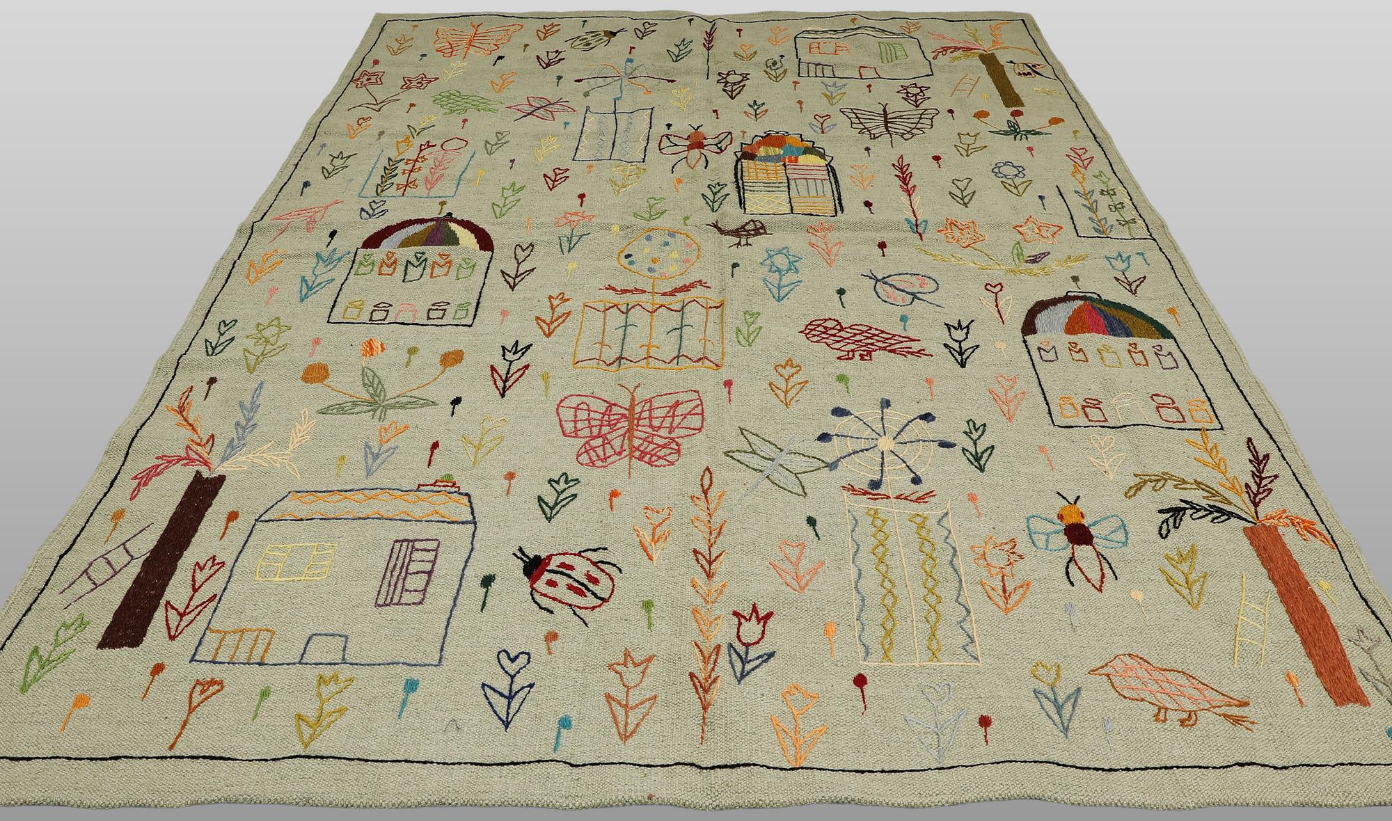 A hand-embroidered Kilim rug, approx. 241 x 183 cm.