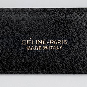CÉLINE, a green suede belt.