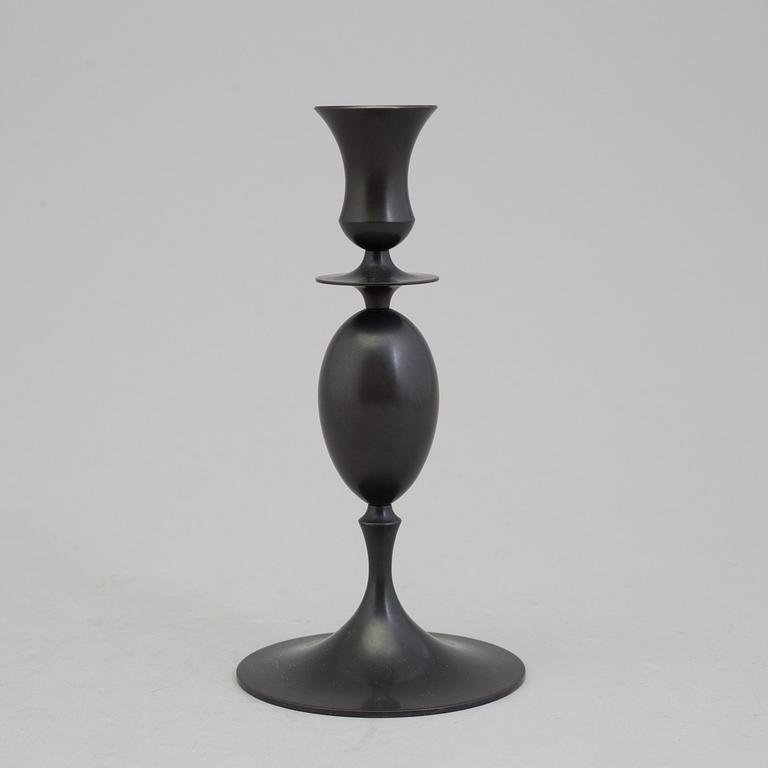 A bronze "Egg and dart candlestick" by E.R. Butler, Ted Muehling.