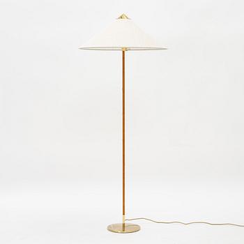 Paavo Tynell, A model 9602 brass and rattan floor lamp with canvas shade from Gubi,