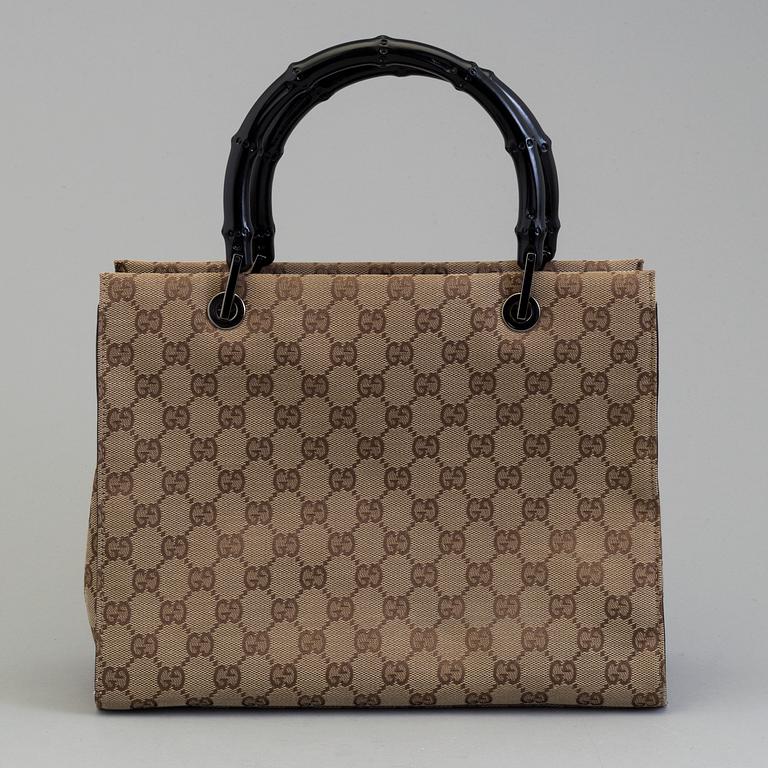 GUCCI, a monogram fabric hand bag and beauty bag.