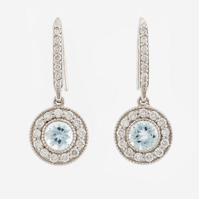 A pair of earrings in 18K white gold with aquamarines and round brilliant-cut diamonds.