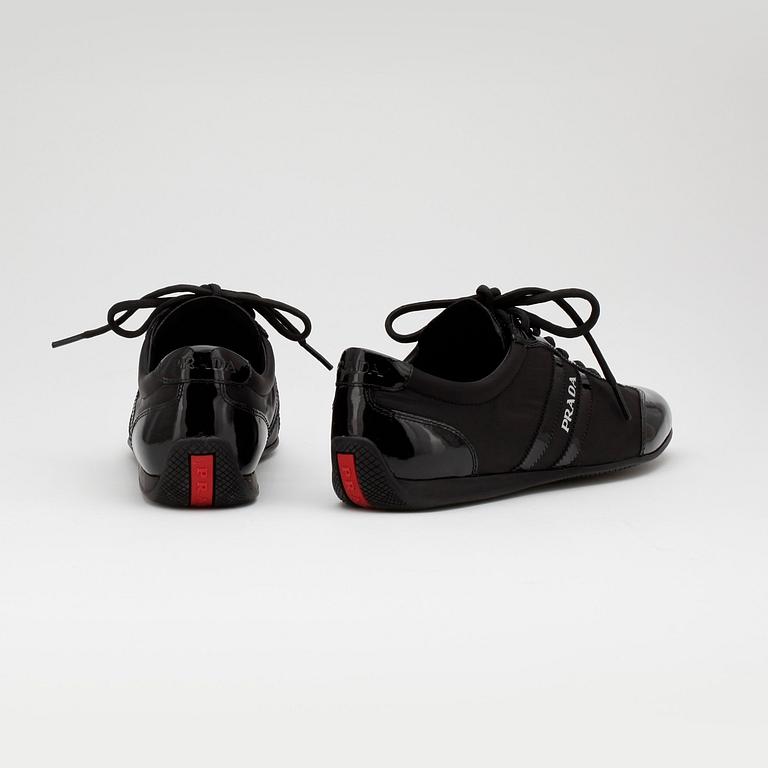 PRADA, a pair of black nylon and leather sneakers.