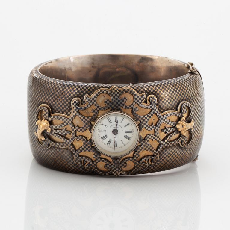 Silver bangle with watch.
