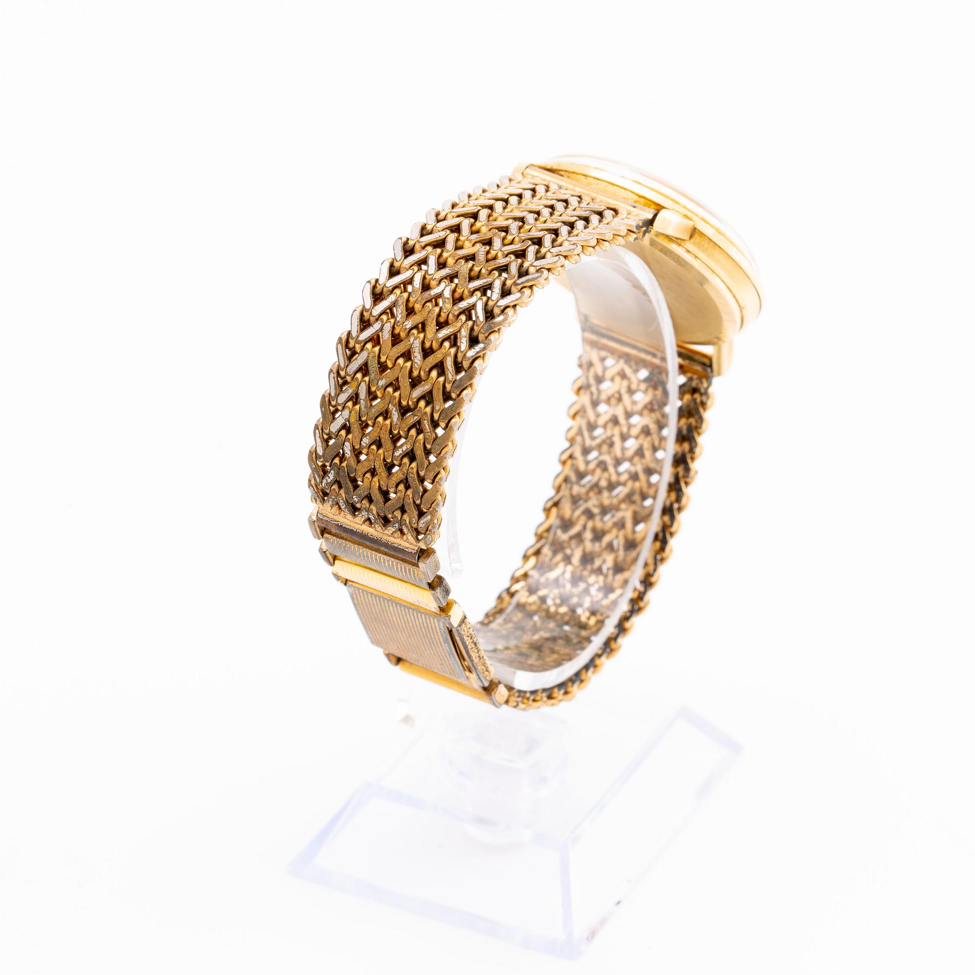 An Omega 14K gold wrist watch.