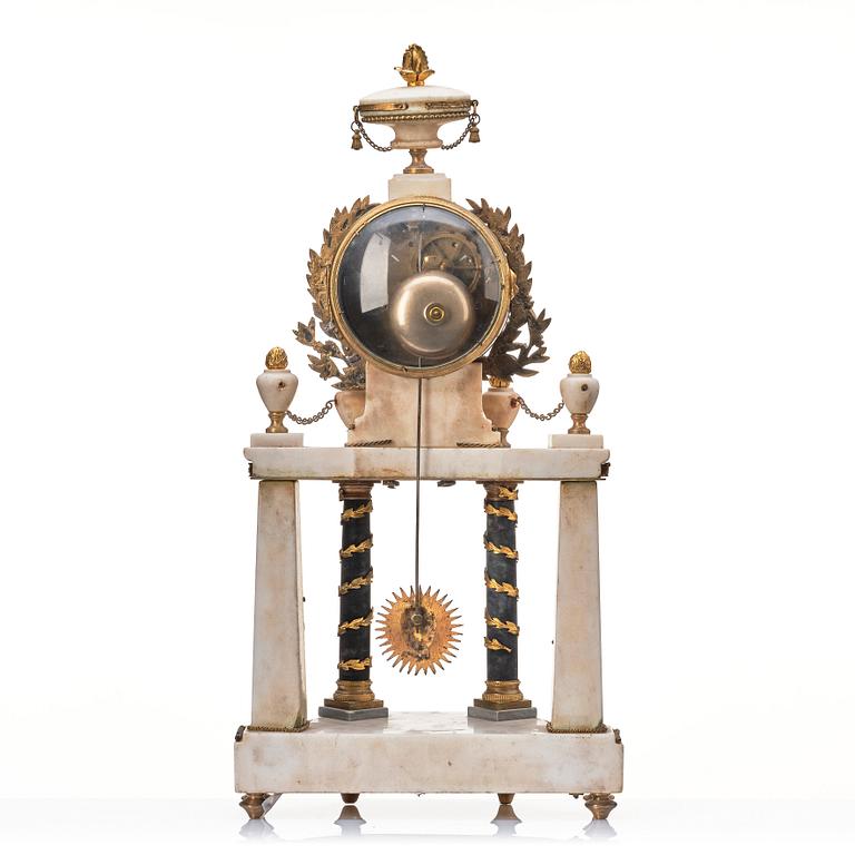 A Louis XVI gilt bronze and white and grey marble mantel clock.