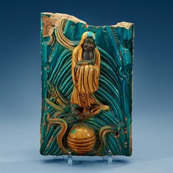 A turquoise and yellow glazed tile piece, Ming dynasty, 17th Century.
