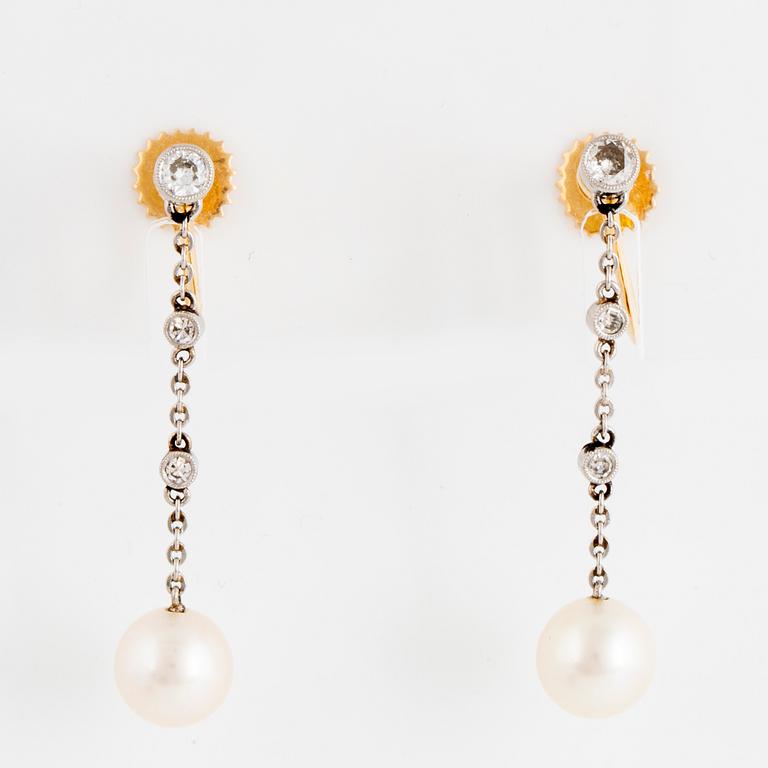 Pearl and diamond earrings.